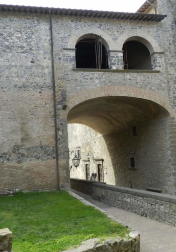 Grand archway between courtyards at Odescalci Castle, Italy.